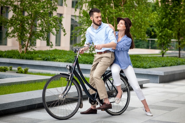 Young couple sitting on a bicycle