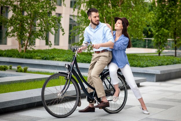 Young couple sitting on a bicycle