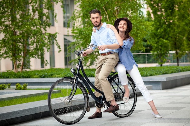 Young couple sitting on a bicycle