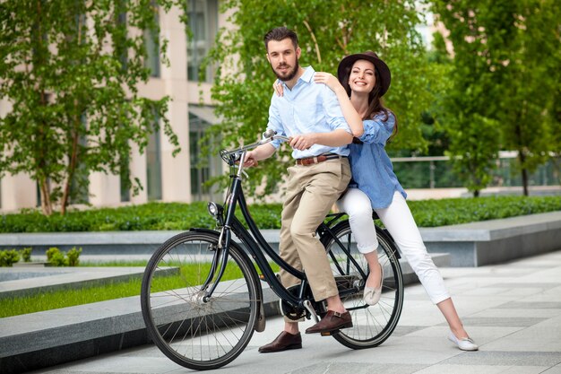 Young couple sitting on a bicycle