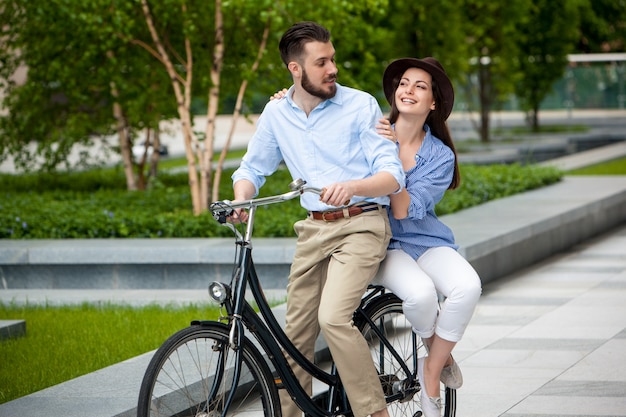 Young couple sitting on a bicycle