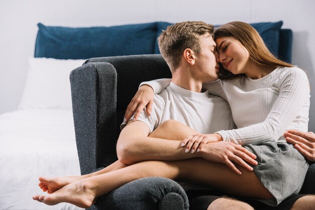 Young couple sleeping in armchair 