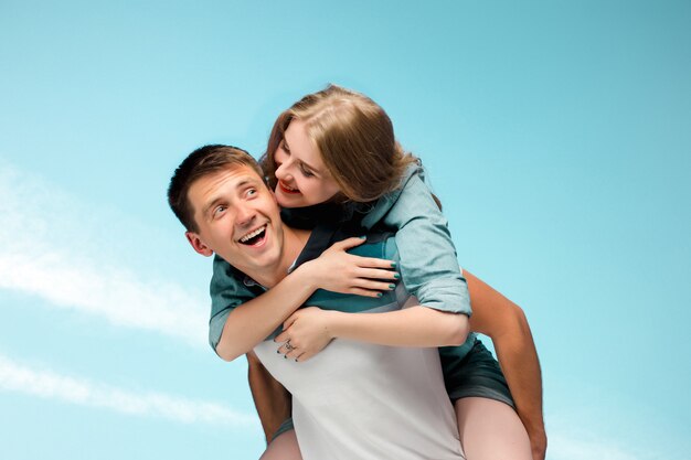 Young couple smiling under blue sky