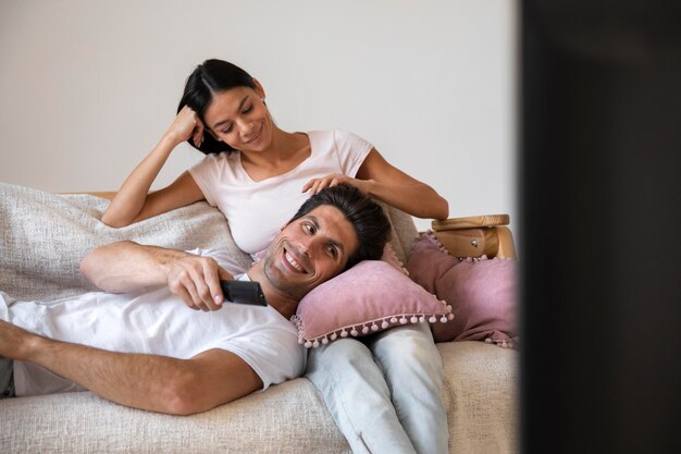 Young couple spending time in front of tv
