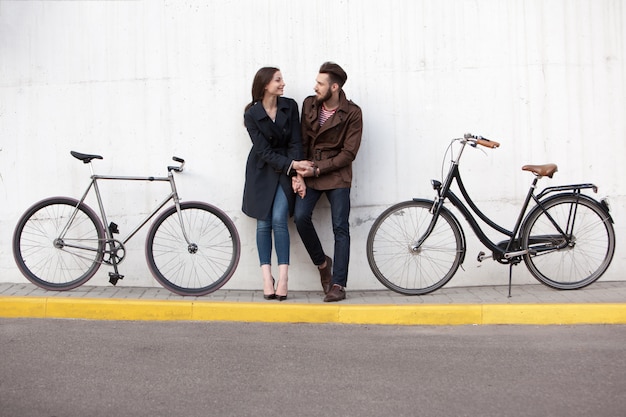 Young couple standing against the wall and hugging