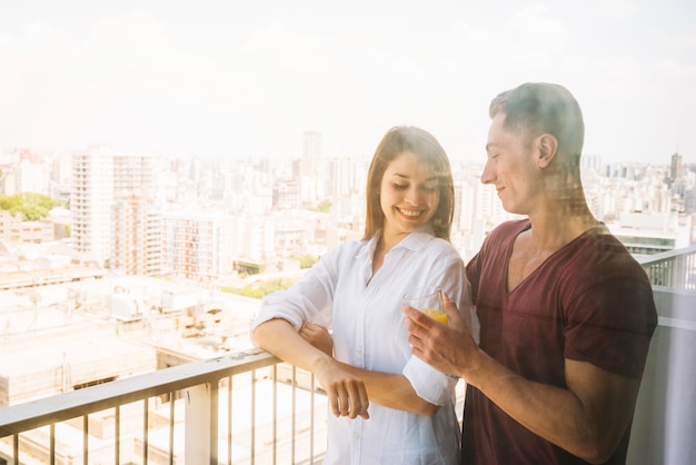 Young couple standing on balcony 