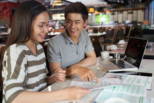 Free photo young couple studying details of life insurance policy