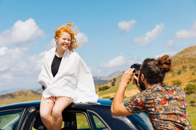 Young couple taking photos outdoors