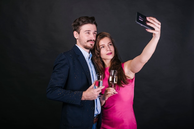 Young couple taking selfie at party