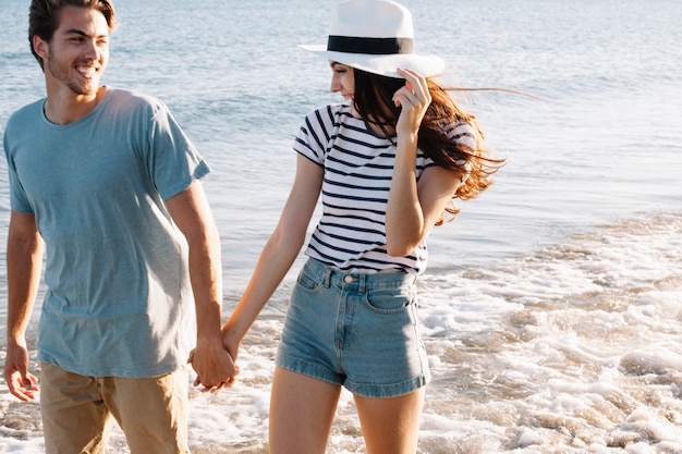 Young couple talking a walk at the beach