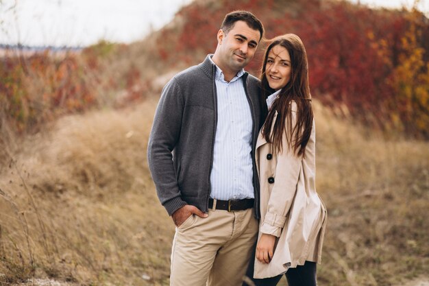 Young couple together in an autumn nature