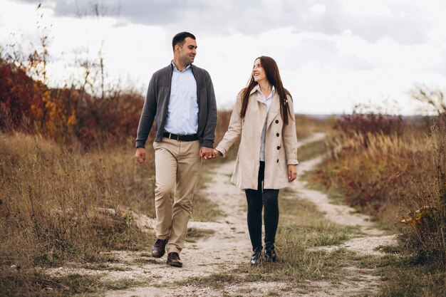 Young couple together in an autumn nature