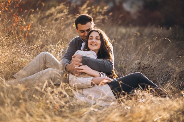 Young couple together in an autumn nature