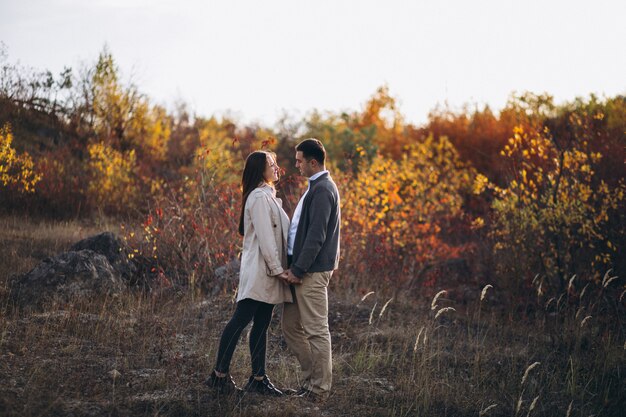 Young couple together in an autumn nature