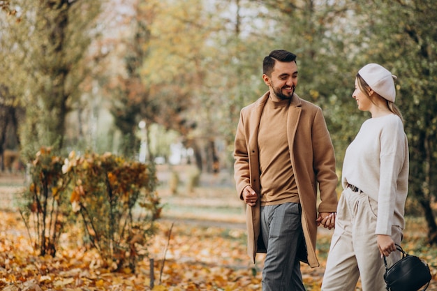 Young couple together in an autumn park