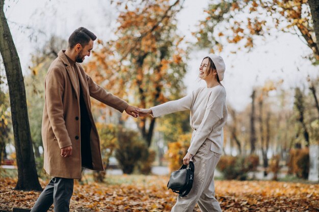 Young couple together in an autumn park