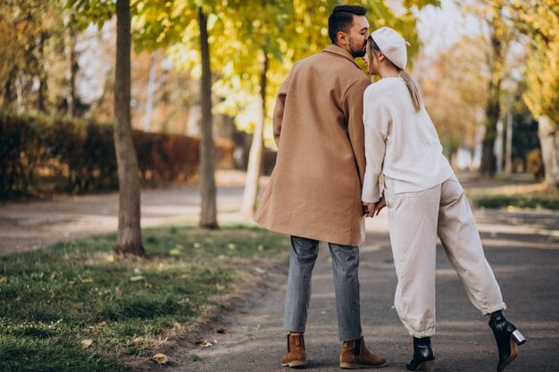 Young couple together in an autumn park