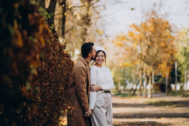 Young couple together in an autumn park