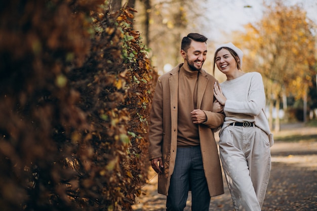 Young couple together in an autumn park