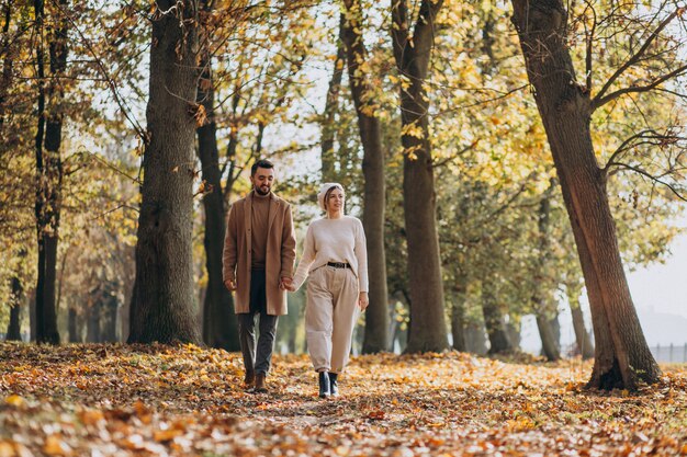 Young couple together in an autumn park
