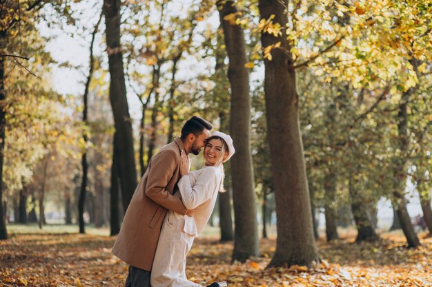 Young couple together in an autumn park