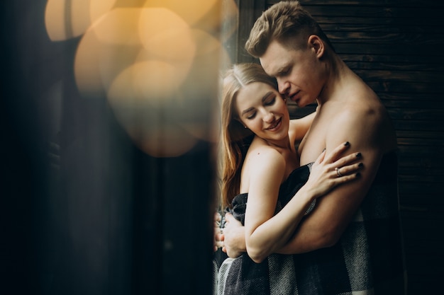 Young couple together under the blanket at home