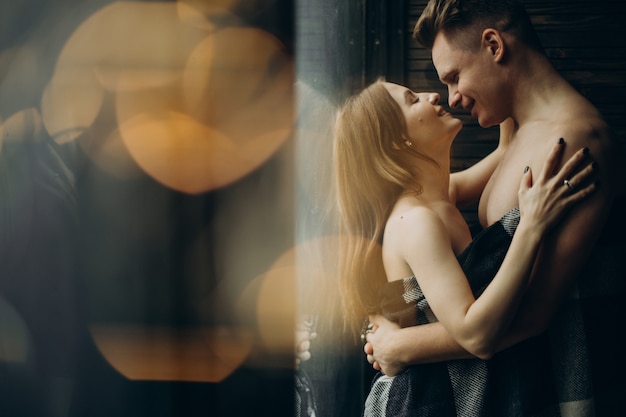 Young couple together under the blanket at home