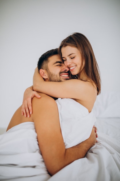 Young couple together lying in bed