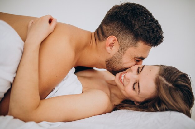 Young couple together lying in bed