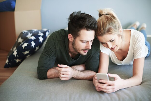 Young couple together surfing the net