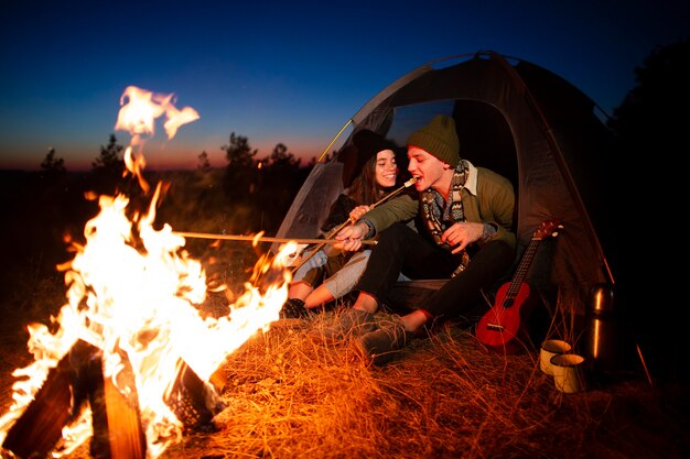 Young couple together with a bonfire