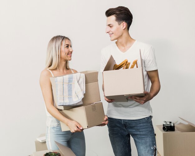 Young couple together with carton boxes