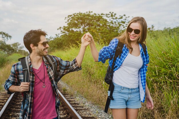 Young couple on train tracks