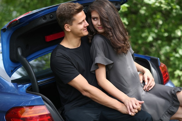 Free photo young couple traveling by car