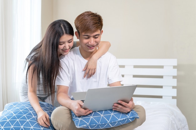 Young couple use technology device on the bed