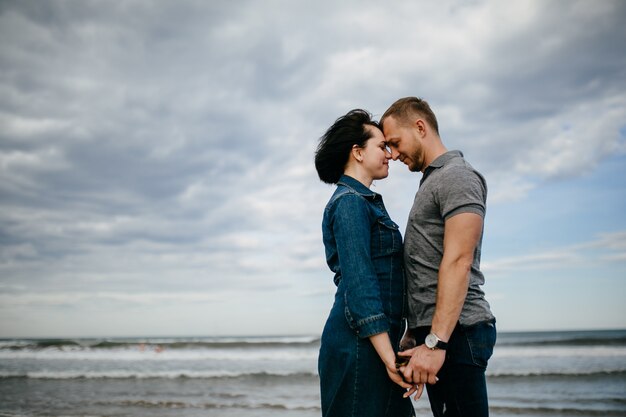 a young couple walking on the beach