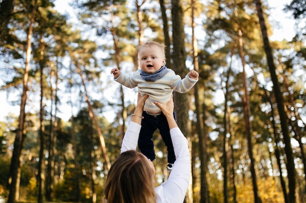 A young couple walks in the woods with a little boy