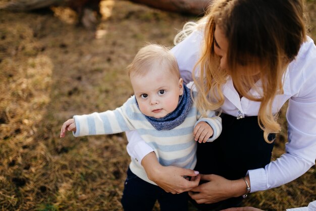 A young couple walks in the woods with a little boy