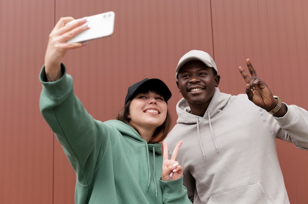 Free photo young couple wearing trucker hat