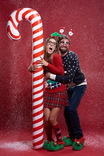 Young couple in weird Christmas clothes
