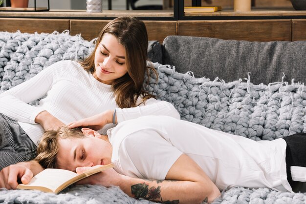 Young couple in white relaxing on couch