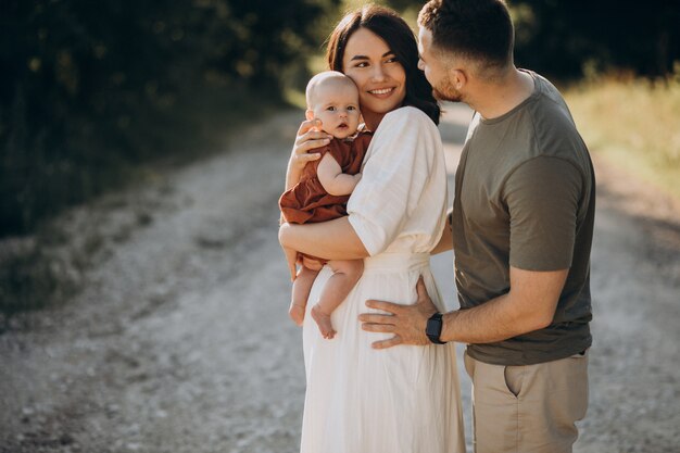 Young couple with baby daughter in park