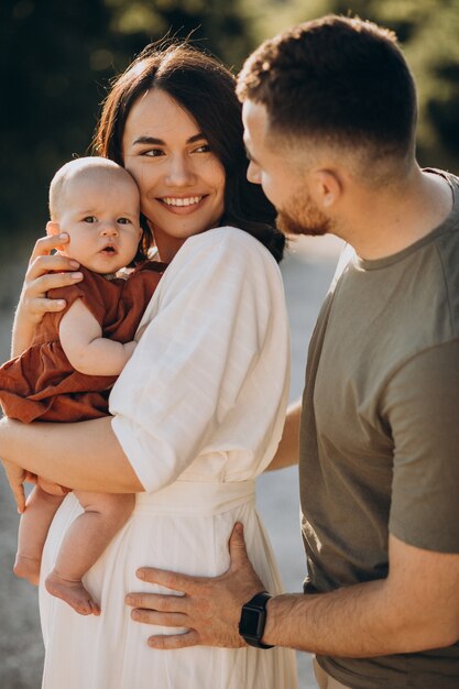 Young couple with baby daughter in park