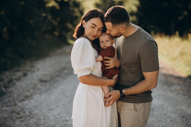 Young couple with baby daughter in park