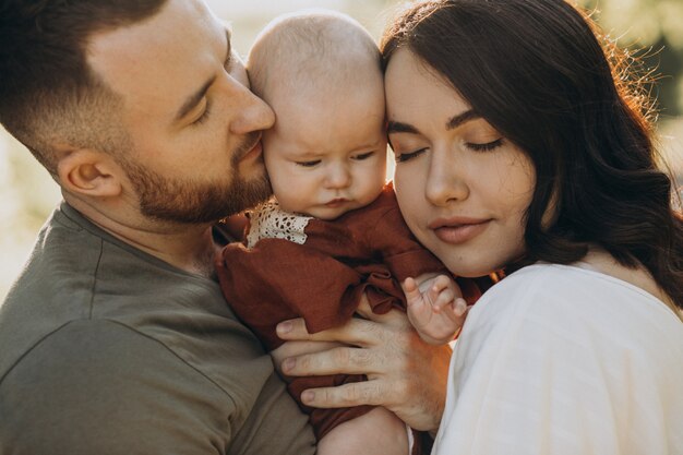 Young couple with baby daughter in park