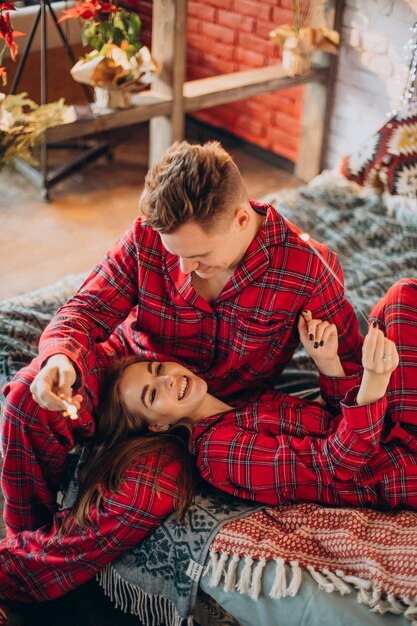 Young couple with bengal lights celebrating