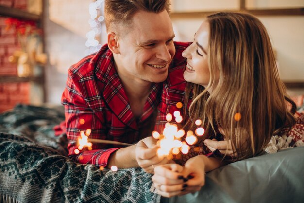 Young couple with bengal lights celebrating