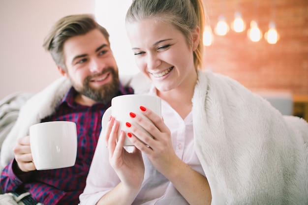 Free photo young couple with cups