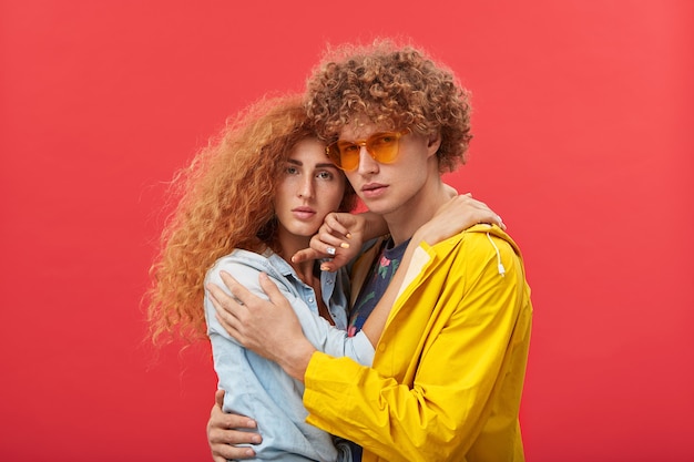 Free photo young couple with curly ginger hair bonding, hugging each other