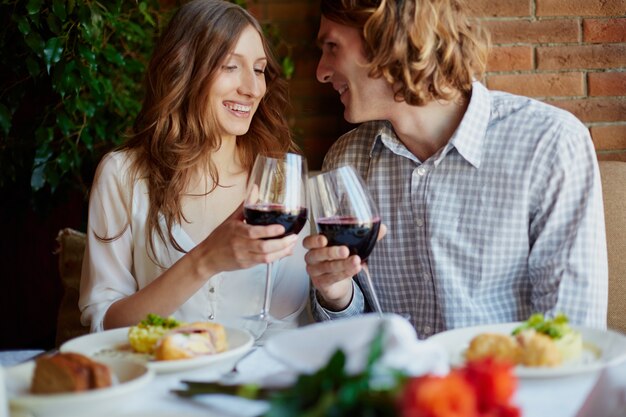 Young couple with glasses of red wine